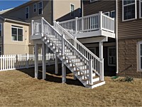 <b>Nice deck with white vinyl railing and stairs to grade showing vinyl wrapped support beams-posts-fascia in Clarksville MD</b>